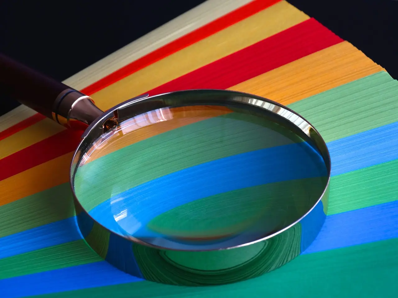 A magnifying glass resting on a sheet of paper